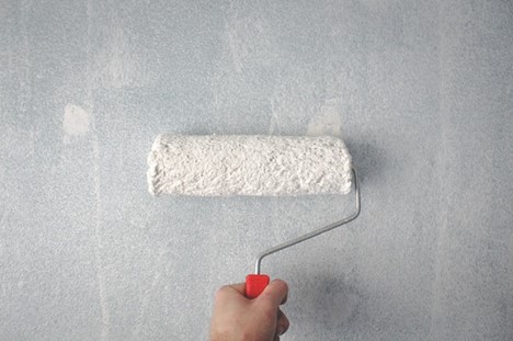 a person holding a paint roller