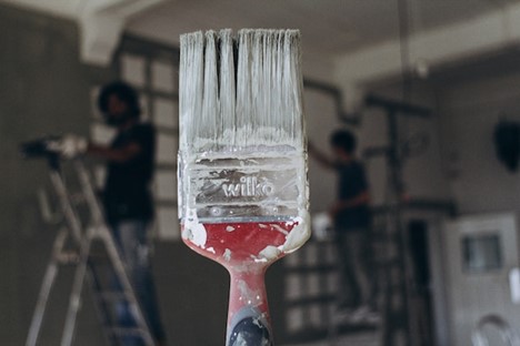 a paintbrush with white paint on it