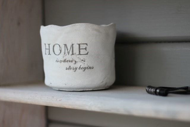 A white pot with 'home' written on it.
